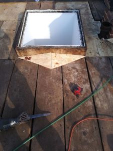 A protective cricket built during a skylight replacement.